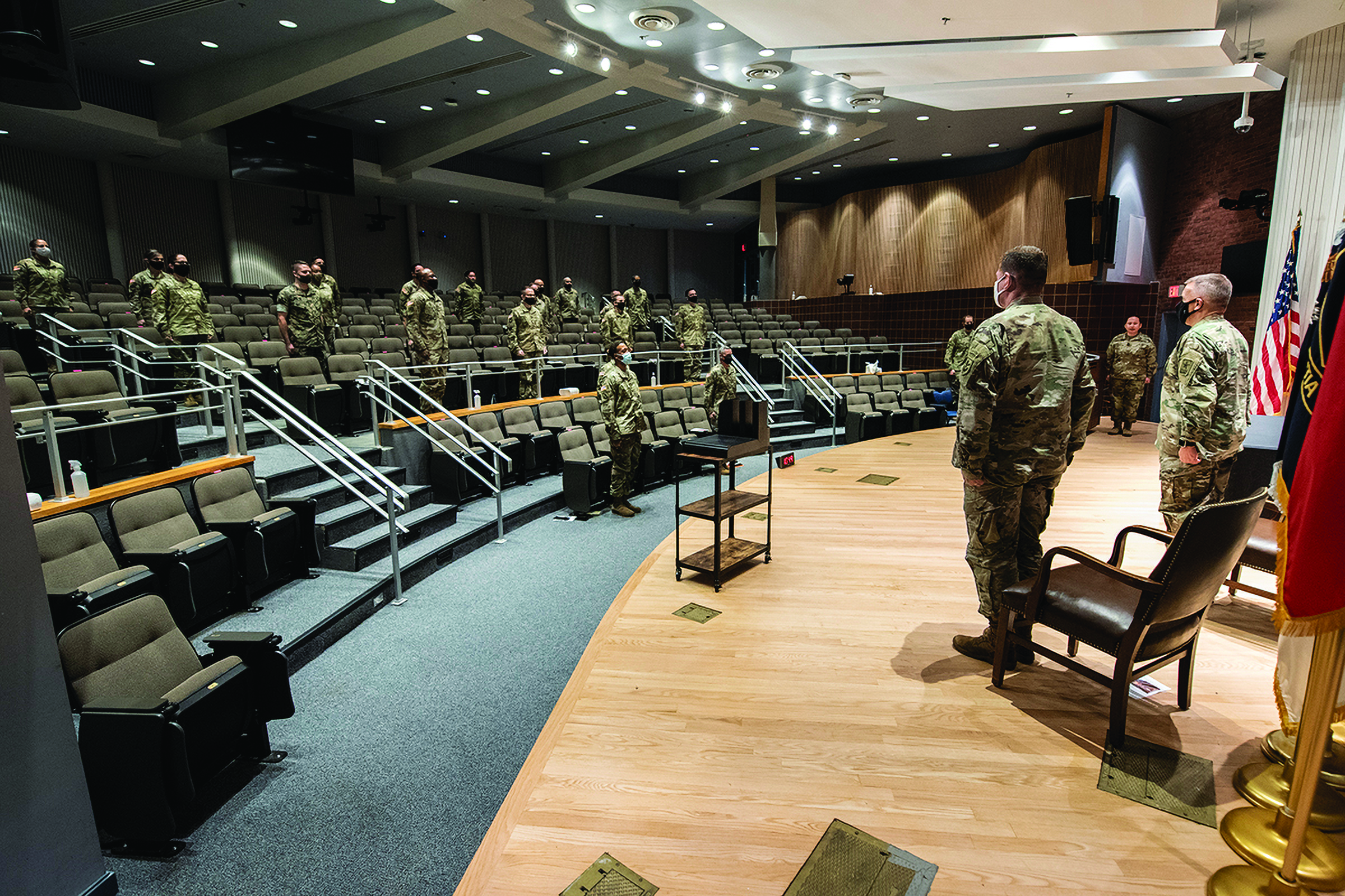 Soldiers wear masks and stand socially-distanced
        during the WOBC graduation ceremony last August
        inside Decker Auditorium at TJAGLCS. (Credit: Jason
        Wilkerson/TJAGLCS)